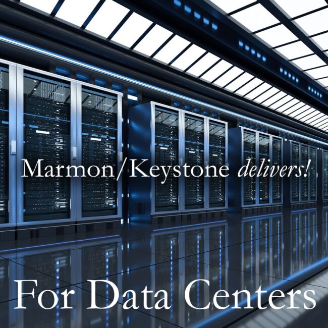 Marmon Keystone A row of server racks with blue LED lights in a modern data center. Overlaid text reads, "Marmon/Keystone delivers! For Data Centers.